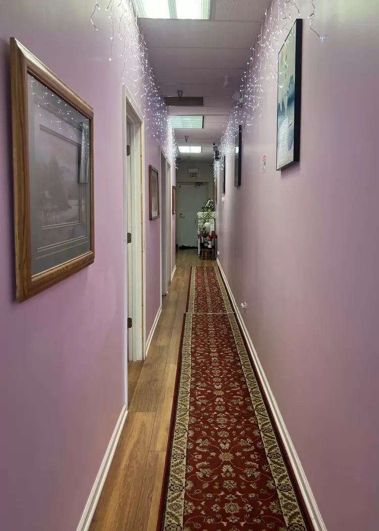 Quiet spa hallway connecting individual massage rooms