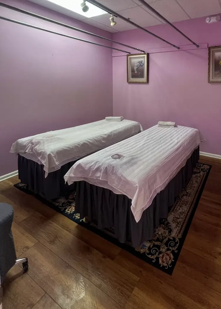 Treatment room featuring warm lighting and massage table setup